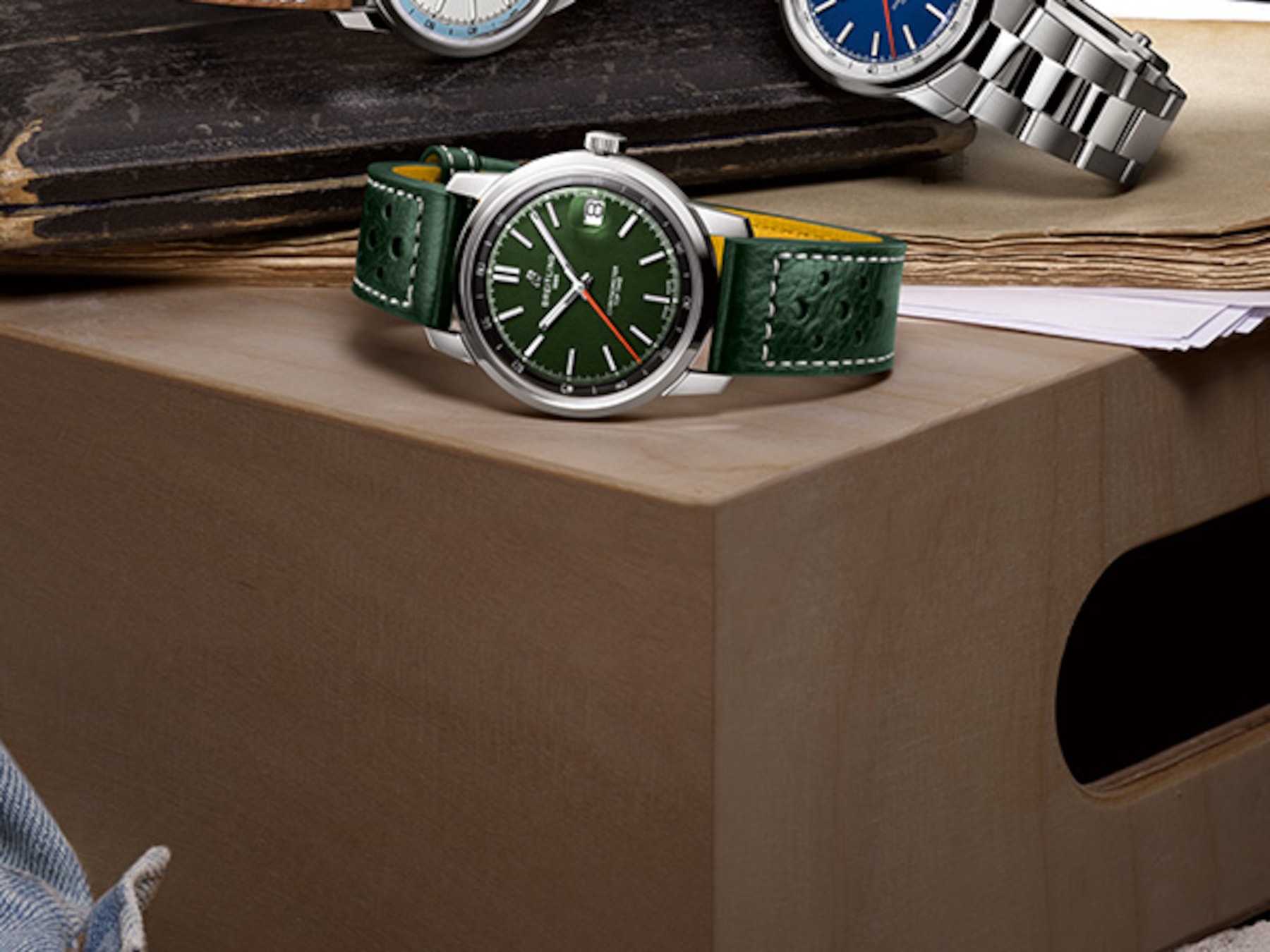 Three Top Time watches with different colored dials and straps on a shiny background.