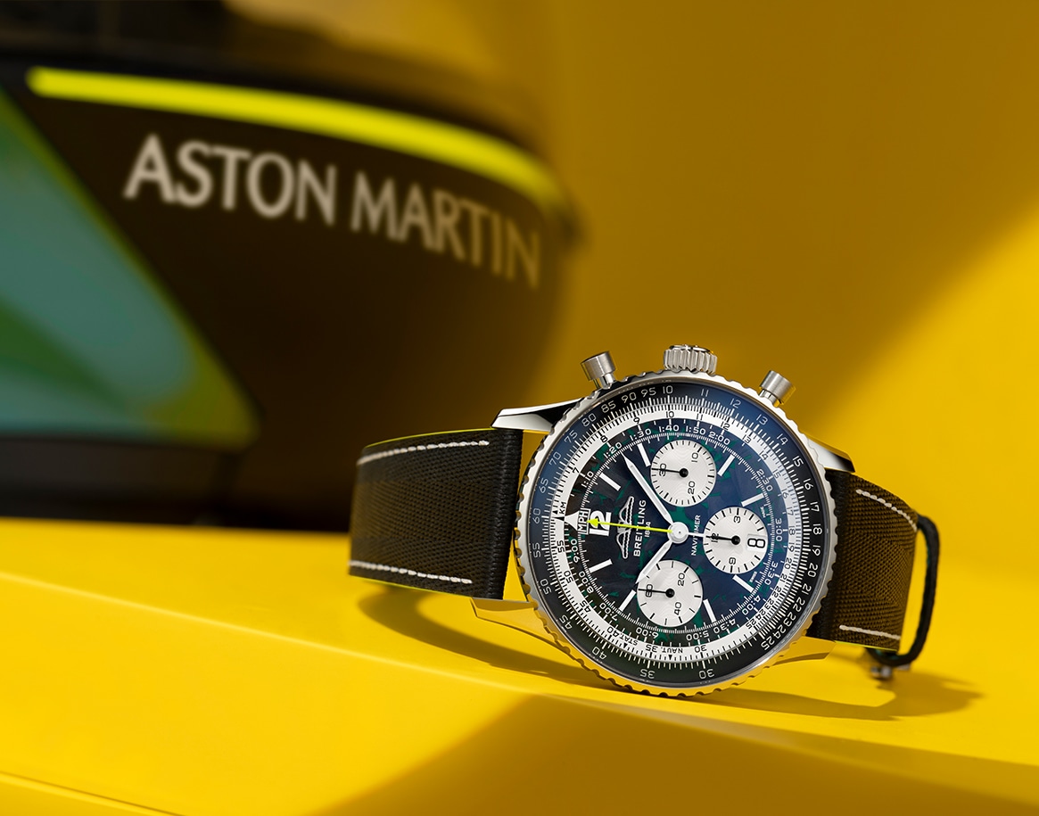 {generated} Breitling Navitimer with Aston Martin Aramco detailing displayed front-on, highlighting its chronograph dial and black strap