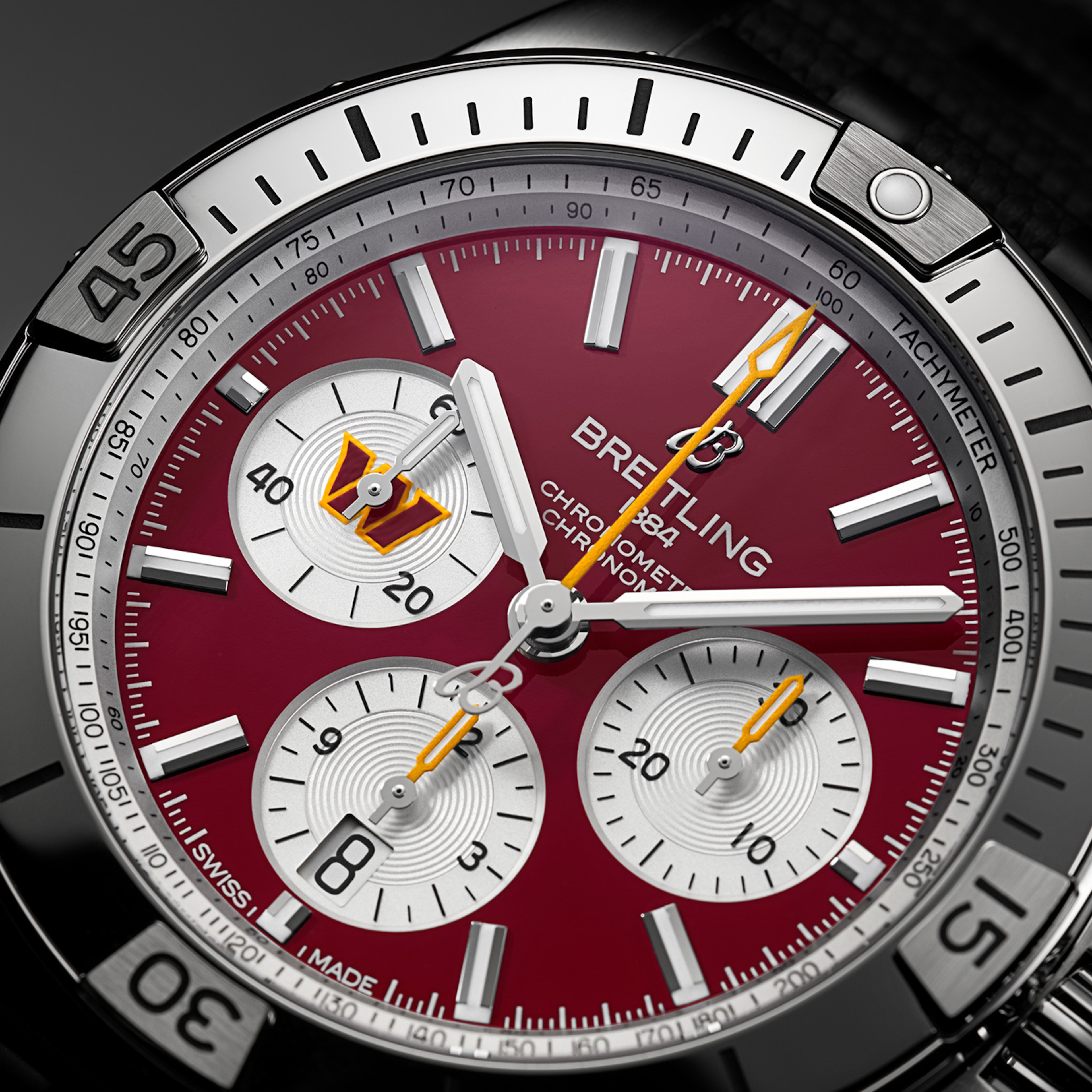 Four Breitling watches from the limited NFL collection with colorful dials and different straps.