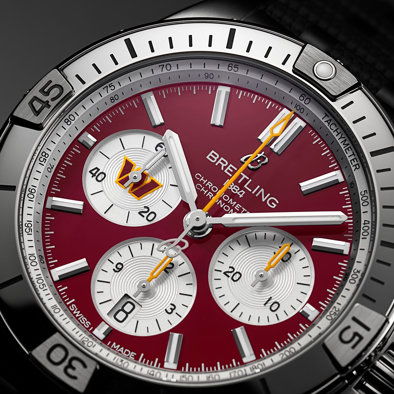 Four Breitling watches from the limited NFL collection with colorful dials and different straps.
