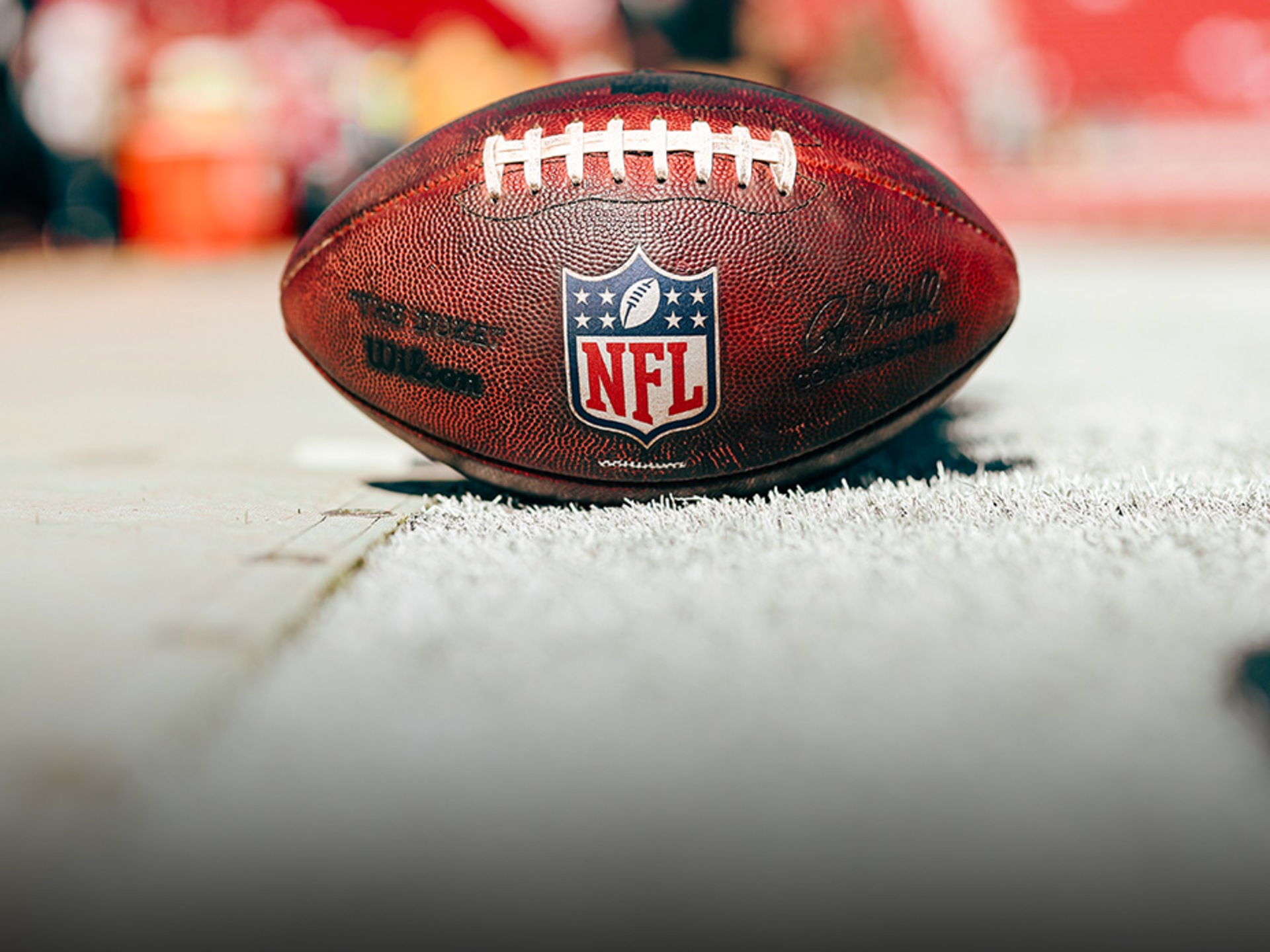 Close-up of a Breitling watch with the NFL logo on the dial