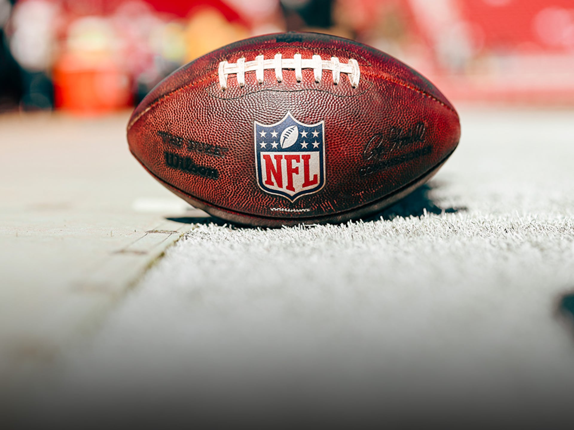 Close-up of a Breitling watch with the NFL logo on the dial