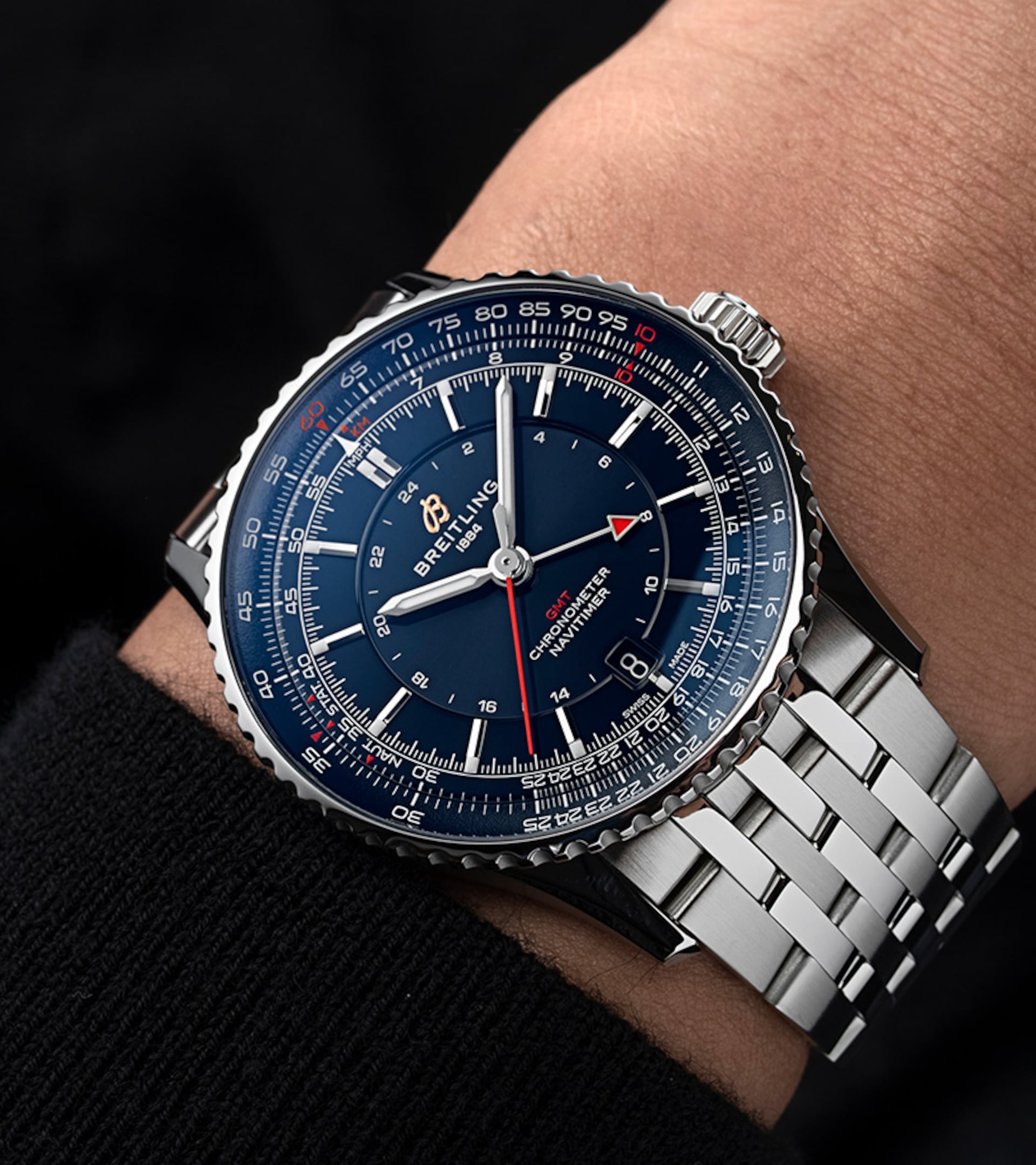 {generated} 腕元のBreitling Navitimer GMT41 Samuraiが青い文字盤と赤いGMT針、ステンレススチールブレスを際立たせる構図。