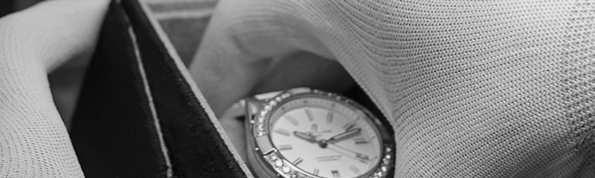 Carefully and with gloves on, a Breitling watch is taken out of its packaging.