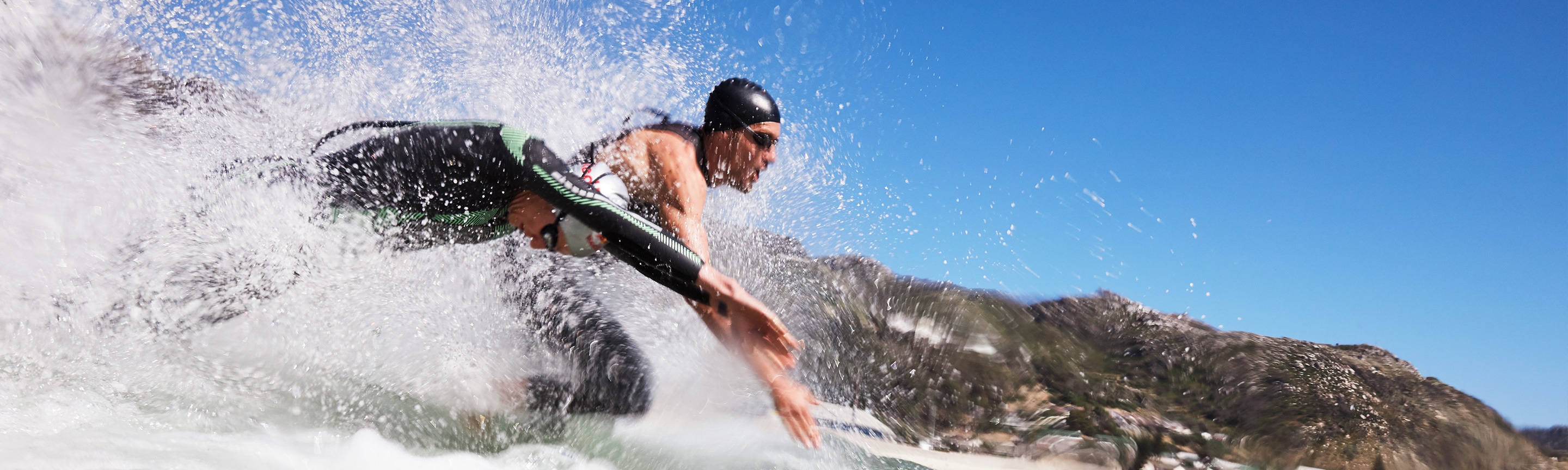 Two Ironman athletes, symbolising the partnership between Breitling and Ironman, jump into the water.