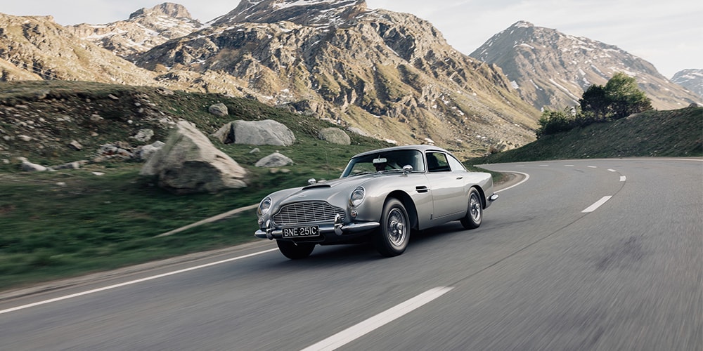 {generated} Sleek grey Aston Martin coupé lit in a studio setting, emphasising the Breitling partnership sign-up theme.