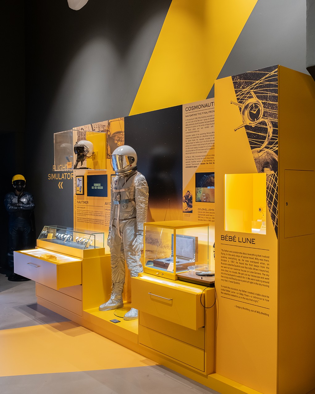 {generated} Space-themed display with astronaut suit, museum cases and imagery highlighting Breitling’s aviation heritage