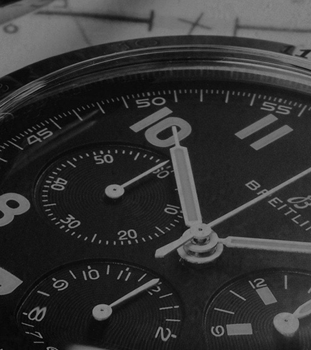 {generated} Close-up of a Breitling Co-Pilot chronograph with black dial and leather strap set against detailed aviation charts.