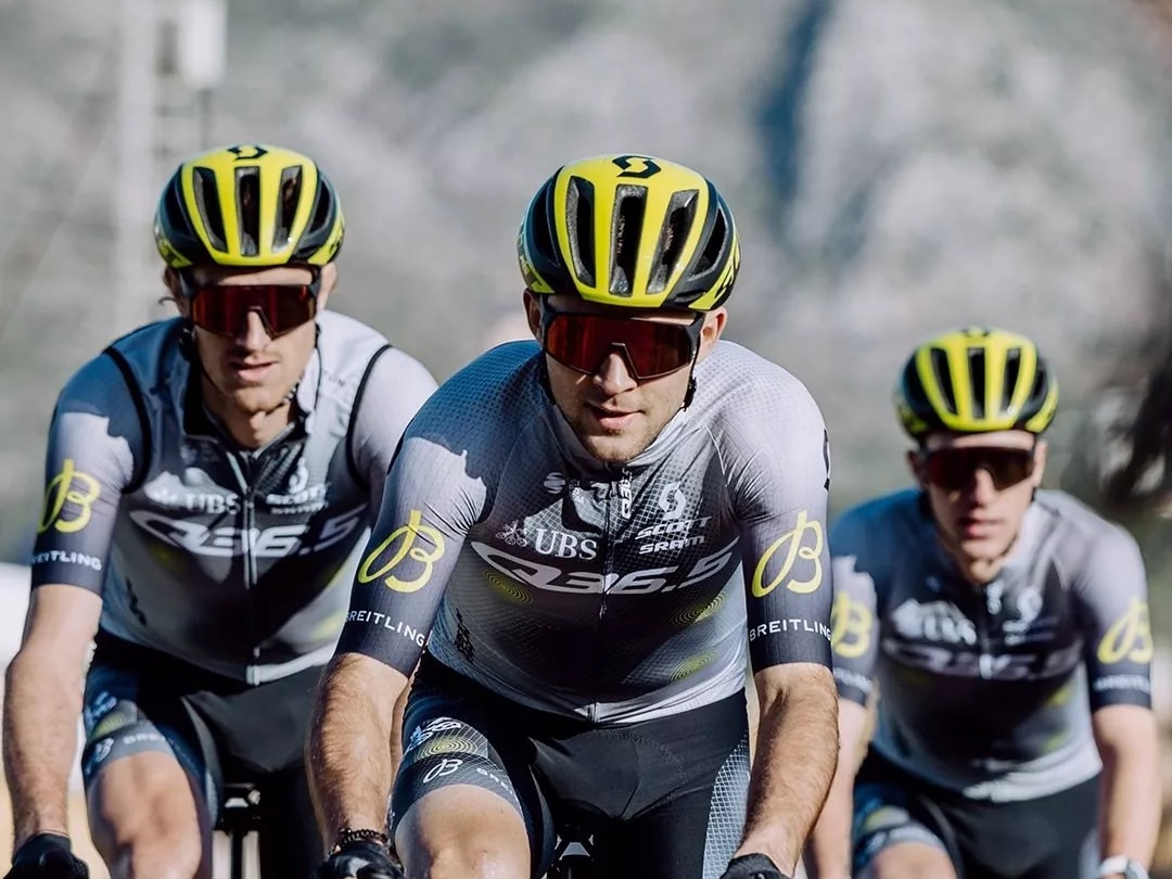 Racers of the Q36.5 PRO CYCLING TEAM wear jerseys with the Breitling logo on their rides.
