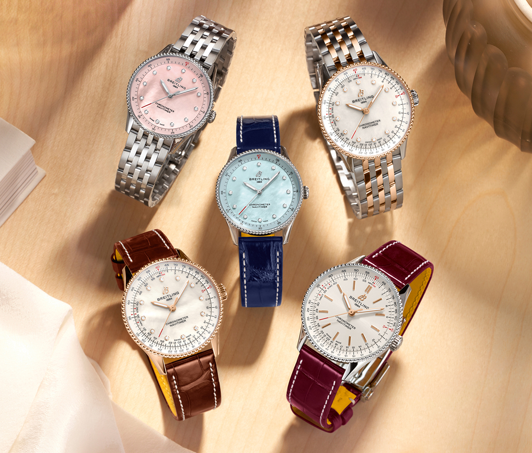 {generated} Collezione Breitling 2023 di Navitimer da donna su una superficie chiara con cinturini colorati e raffinati bracciali in acciaio