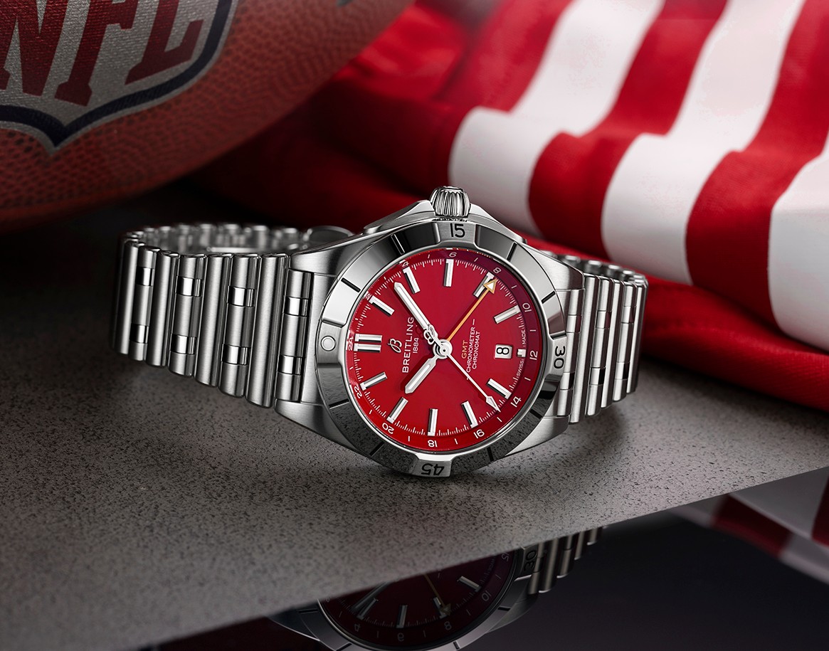 {generated} Breitling Chronomat with a bold red dial set beside a football and striped fabric evoking the San Francisco 49ers