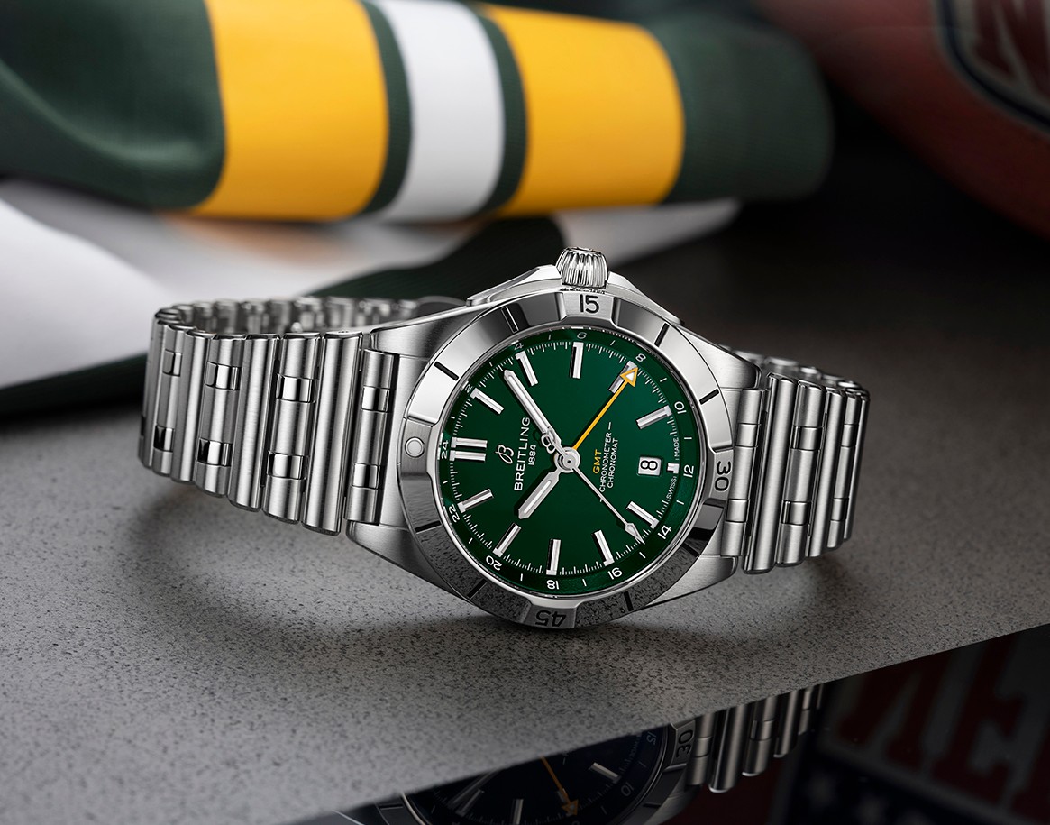 {generated} Breitling Chronomat GMT with green dial displayed on steel bracelet against Green Bay Packers colors for team edition