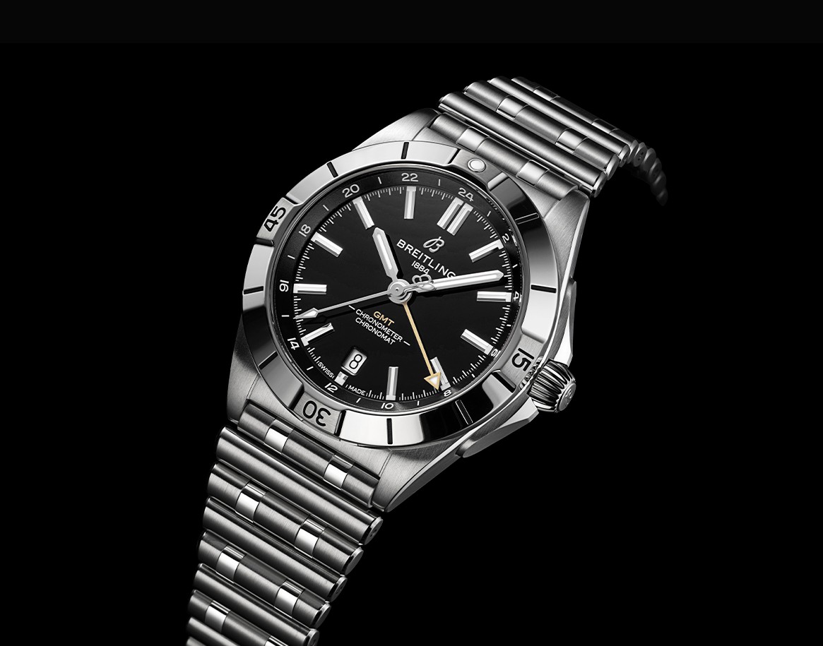 {generated} Breitling Chronomat GMT with black dial and steel bracelet presented against black backdrop, linked to New Orleans Saints.