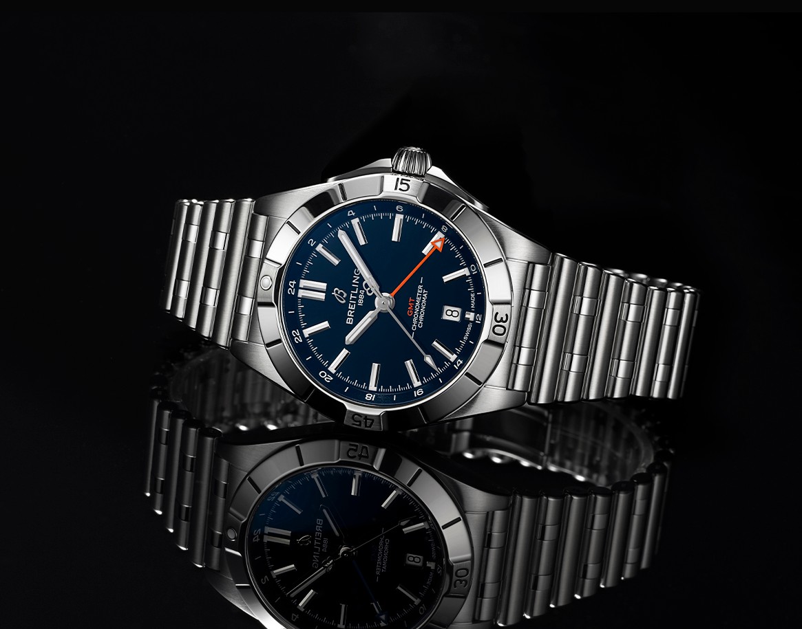 {generated} Breitling Chronomat GMT in blue with steel bracelet shown against a dark reflective surface for the Chicago Bears collection