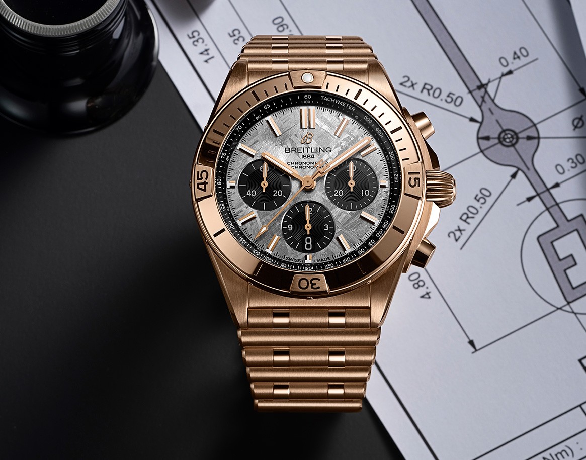 {generated} Erling Haaland’s Breitling Chronomat shown in rose gold on technical drawings, highlighting its refined chronograph design