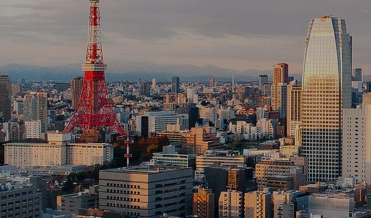 {generated} Tokyo’s skyline at sunset with the iconic red tower and modern high-rises creating a warm, expansive city panorama.