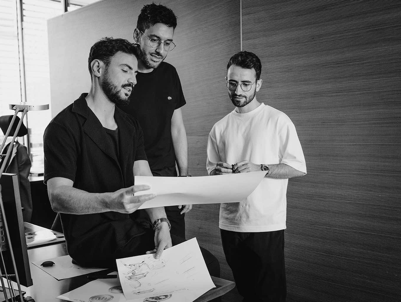 {generated} Design team reviews sketches in a modern studio, highlighting collaborative Breitling creativity and craftsmanship.