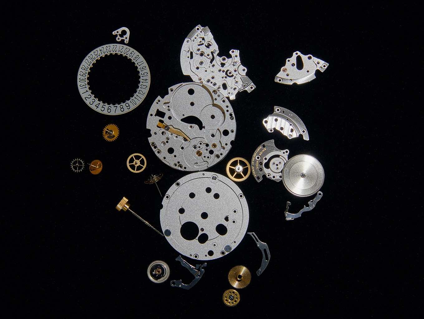 {generated} Precision Breitling watch components arranged on black, highlighting Swiss‑made craftsmanship with intricate gears, plates