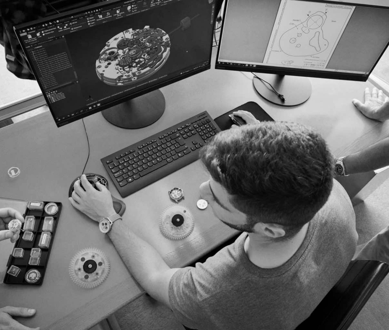 {generated} Engineers collaborate at a workstation reviewing Breitling movement components and patent drawings for precision innovation
