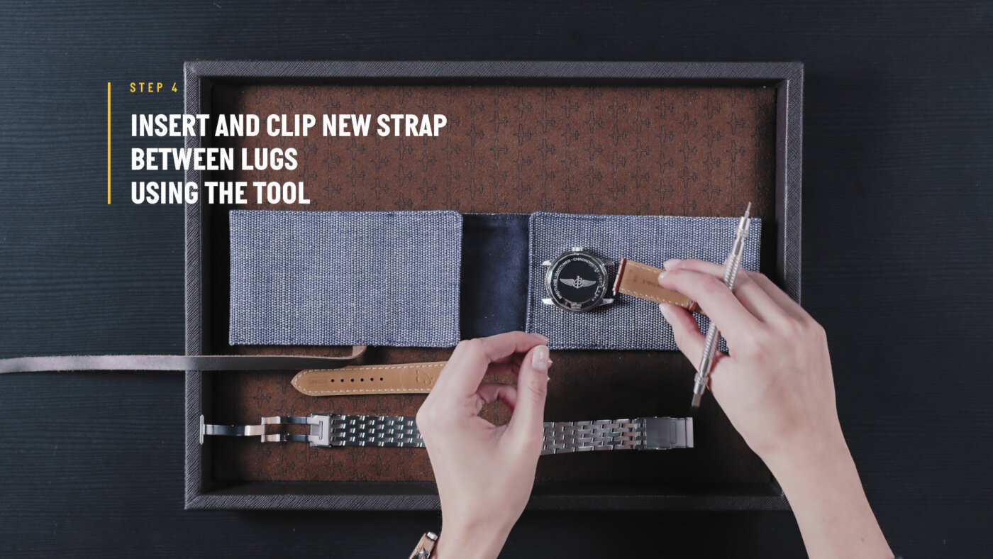 {generated} Руки с помощью инструмента устанавливают кожаный ремень Breitling, точно размещая его между ушками в аккуратном наборе.