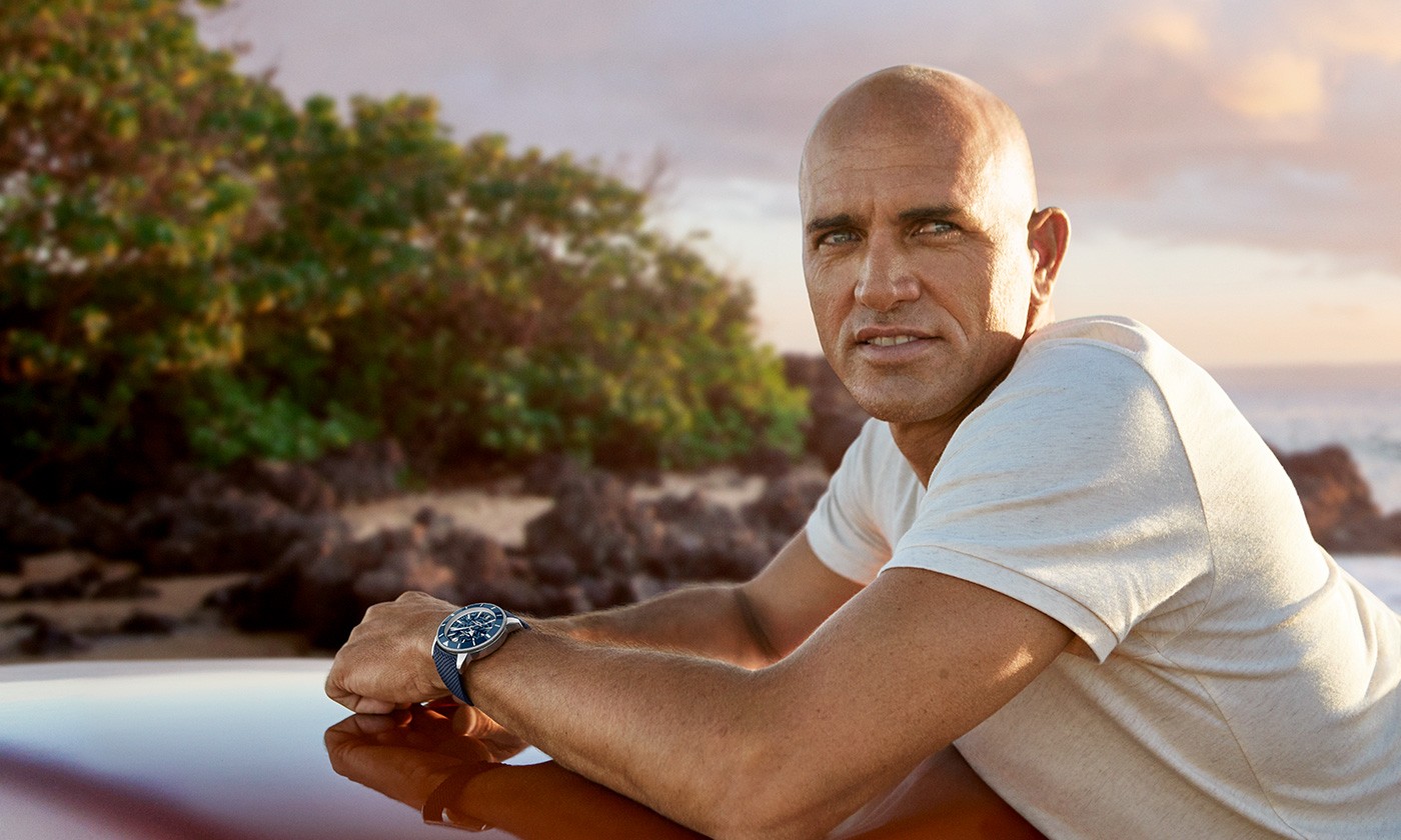 {generated} Breitling Superocean Heritage with blue floral dial and textured strap shown in a close-up with Kelly Slater
