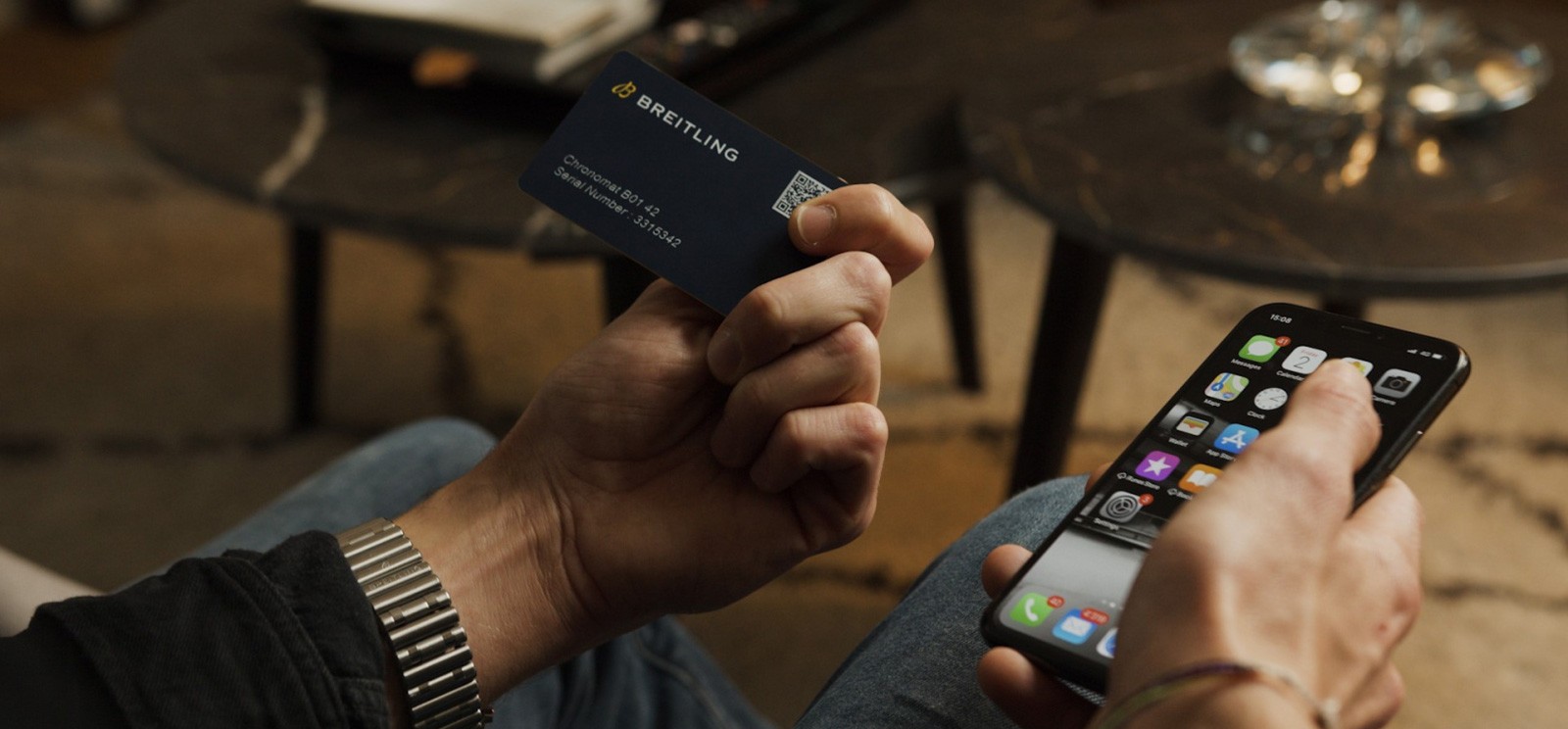 {generated} Hands holding a Breitling digital passport card beside a smartphone, highlighting secure watch authentication.