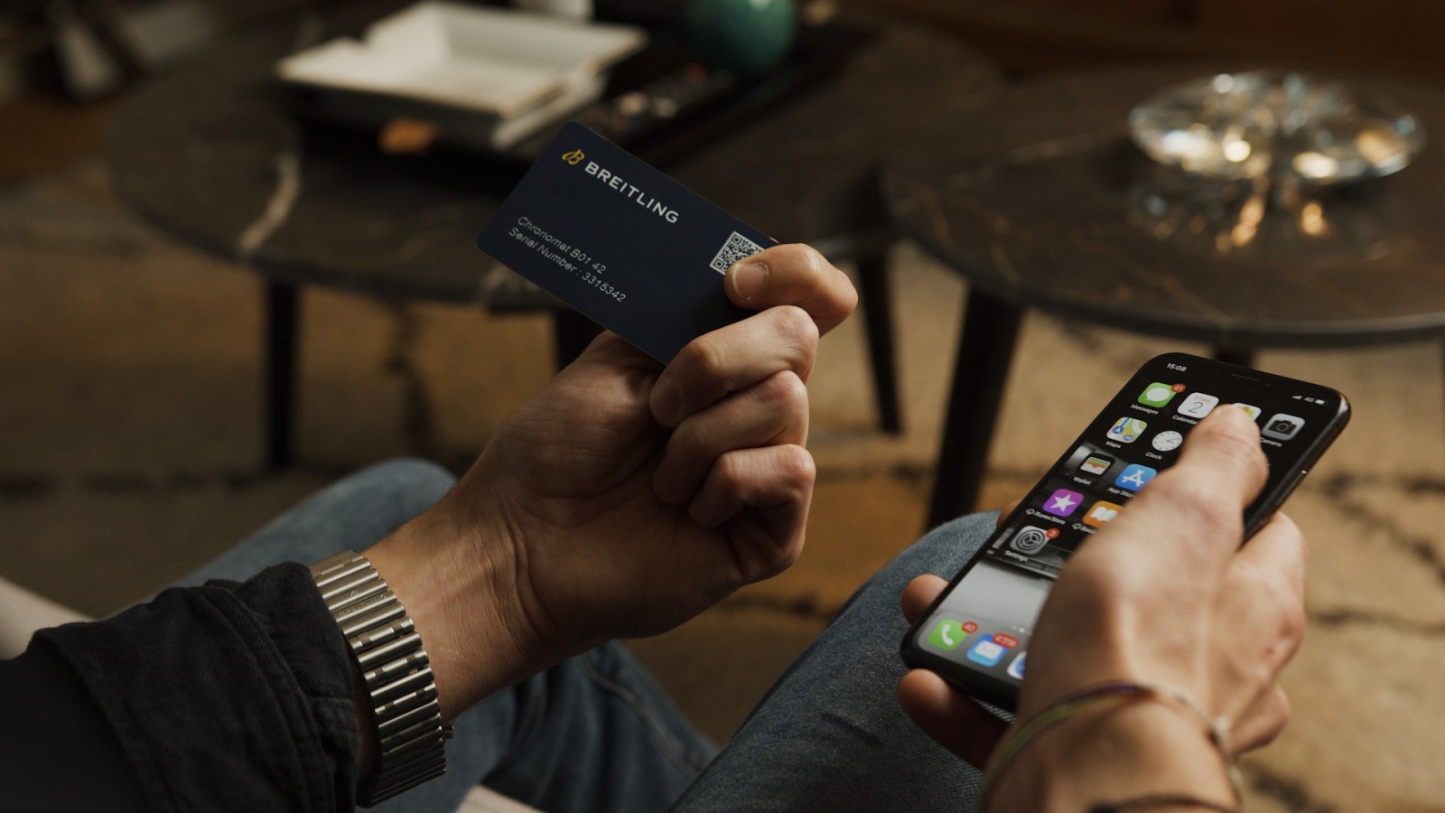 {generated} Hands hold a Breitling digital passport card beside a smartphone, highlighting secure product authentication.