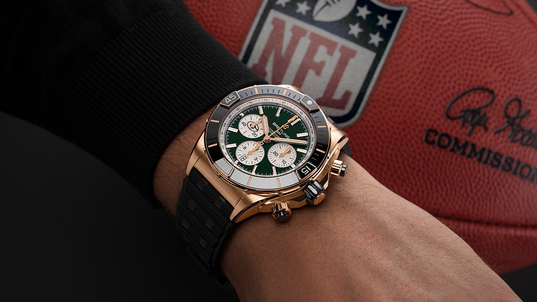 {generated} Breitling Chronomat Green Bay Packers edition on wrist beside NFL football, highlighting team colors and details
