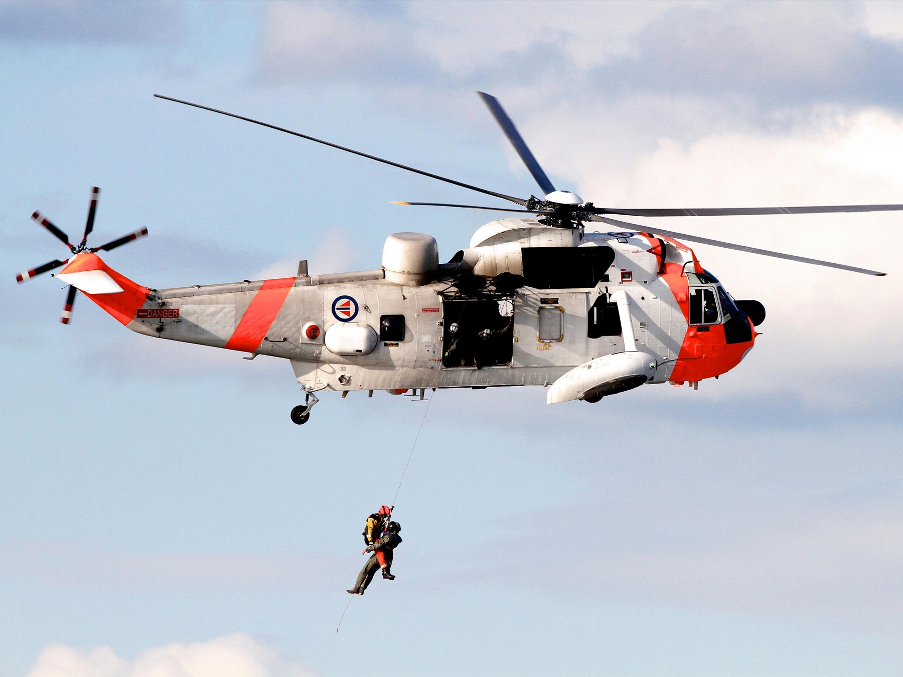 {generated} Rescue helicopter hovers as crew member descends on a line, echoing the mission‑ready spirit of the Breitling Emergency.