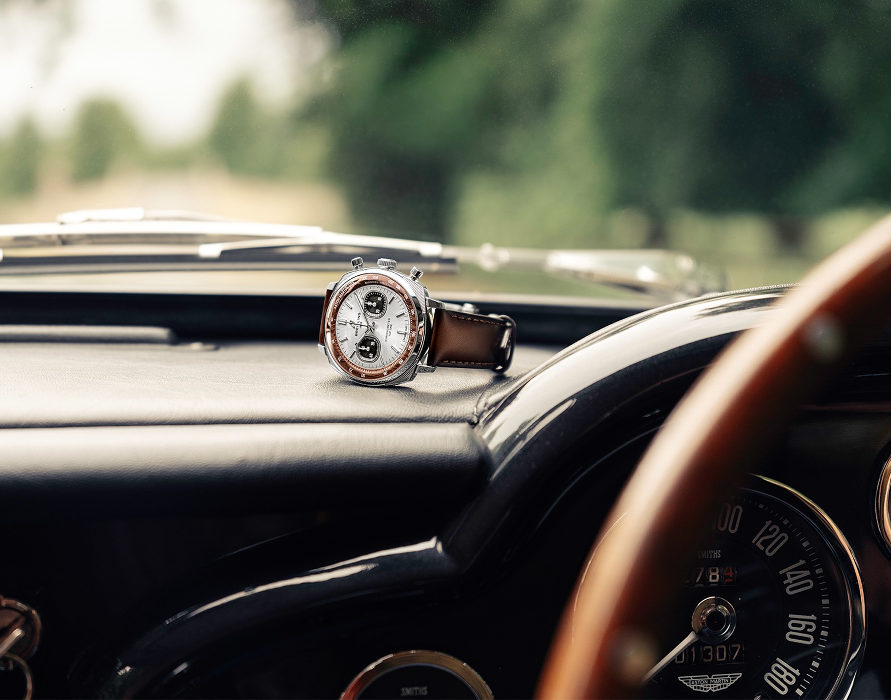 {generated} Breitling Top Time Tribute to Aston Martin DB5 steel chronograph on a classic car dashboard interior