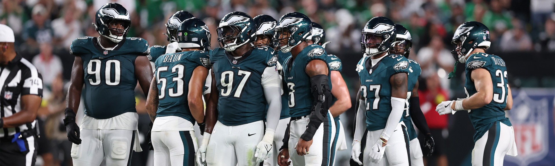 {generated} Philadelphia Eagles players celebrate a major play on the field as cheering fans in green fill the stadium backdrop.