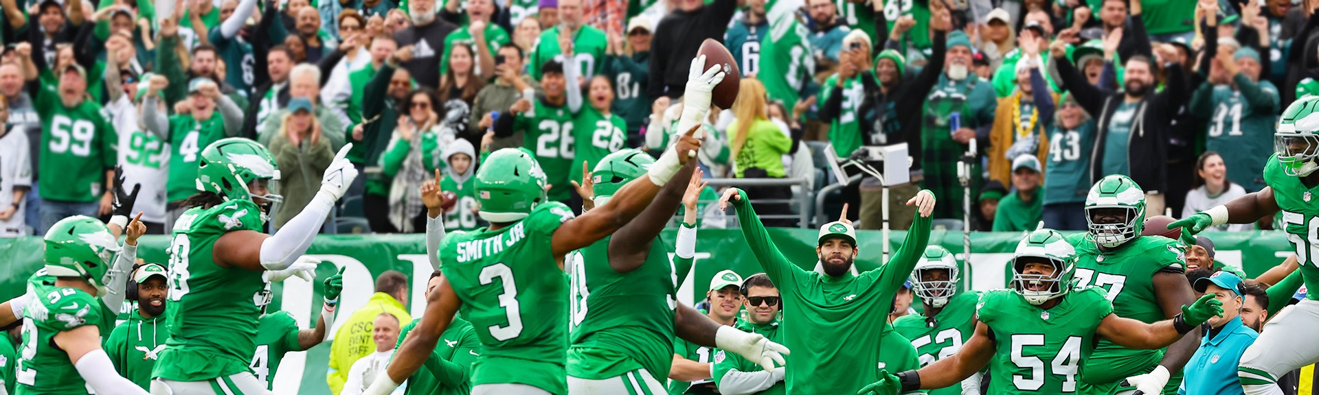 {generated} Philadelphia Eagles players celebrate a big play on the field as cheering fans in green fill the stadium backdrop.