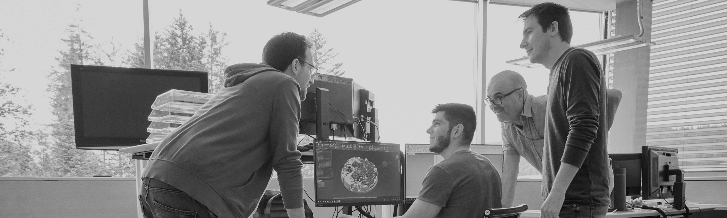 {generated} Engineers examine intricate digital schematics across several screens within a bright Breitling research and development space