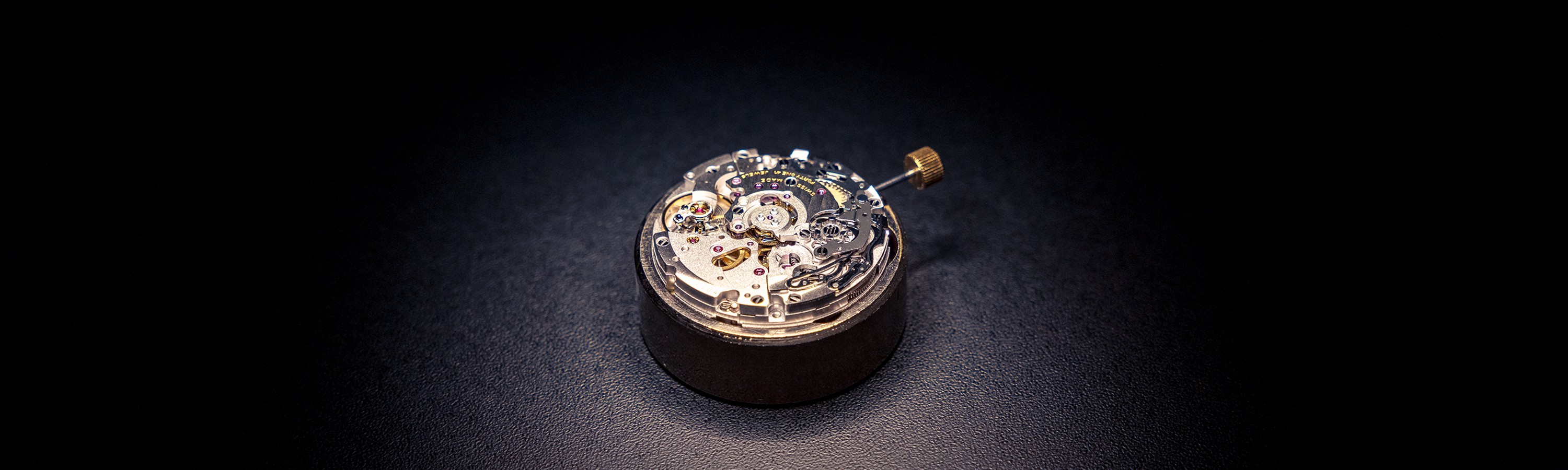 {generated} Mouvement Breitling posé sur une surface sombre, révélant des rouages fins et un savoir‑faire inspiré de Triumph