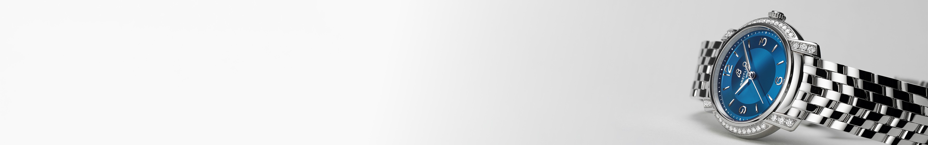 {generated} Breitling diamond-set watch with blue dial and polished steel bracelet displayed against a clean light background