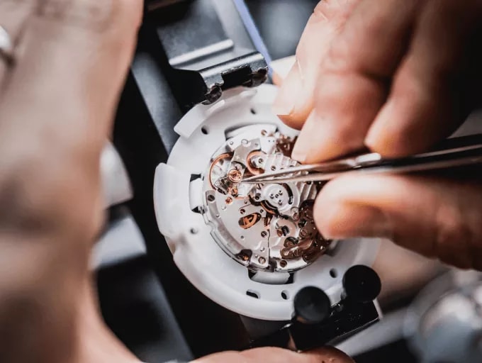 {generated} Hands delicately assembling a Breitling movement, highlighting intricate components and expert watchmaking craft