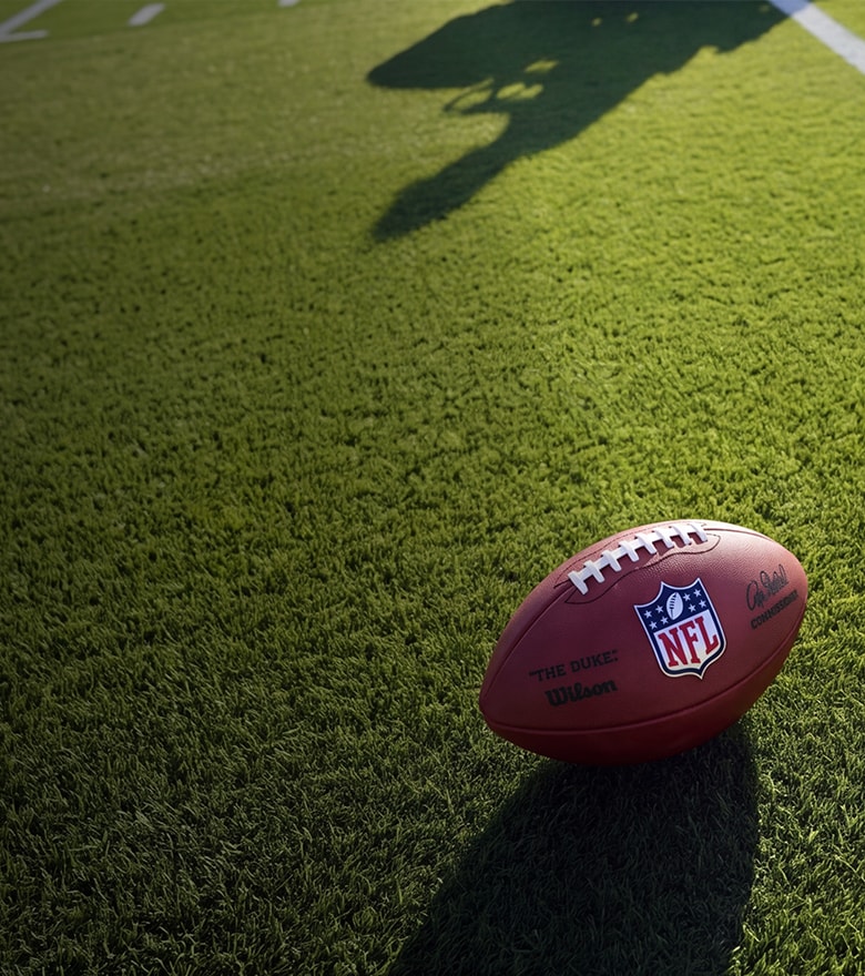 {generated} A yellow football helmet with a bold Breitling B emblem set against a bright sky, signalling an NFL sign-up countdown moment.