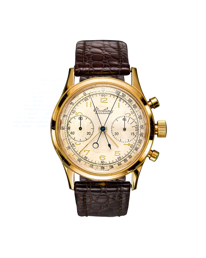 {generated} Vintage Breitling Duograph ref.764 Venus 179 shown with a gold chronograph case, cream dial and brown leather strap.