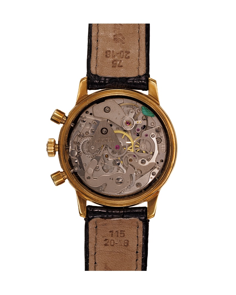 {generated} Breitling Top Time Long Playing ref. 815 con cassa cronografo dorata, quadranti scuri e cinturino in pelle nera testurizzata