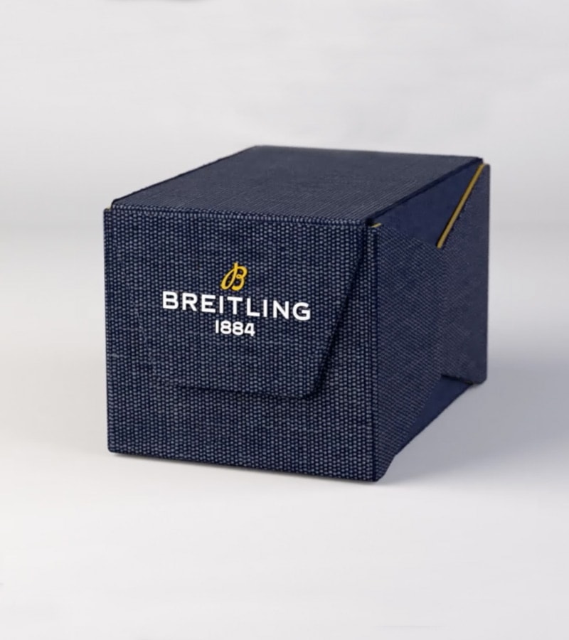 {generated} A navy textured box displaying the Breitling logo, highlighting the brand’s refined watch packaging against a clean backdrop.