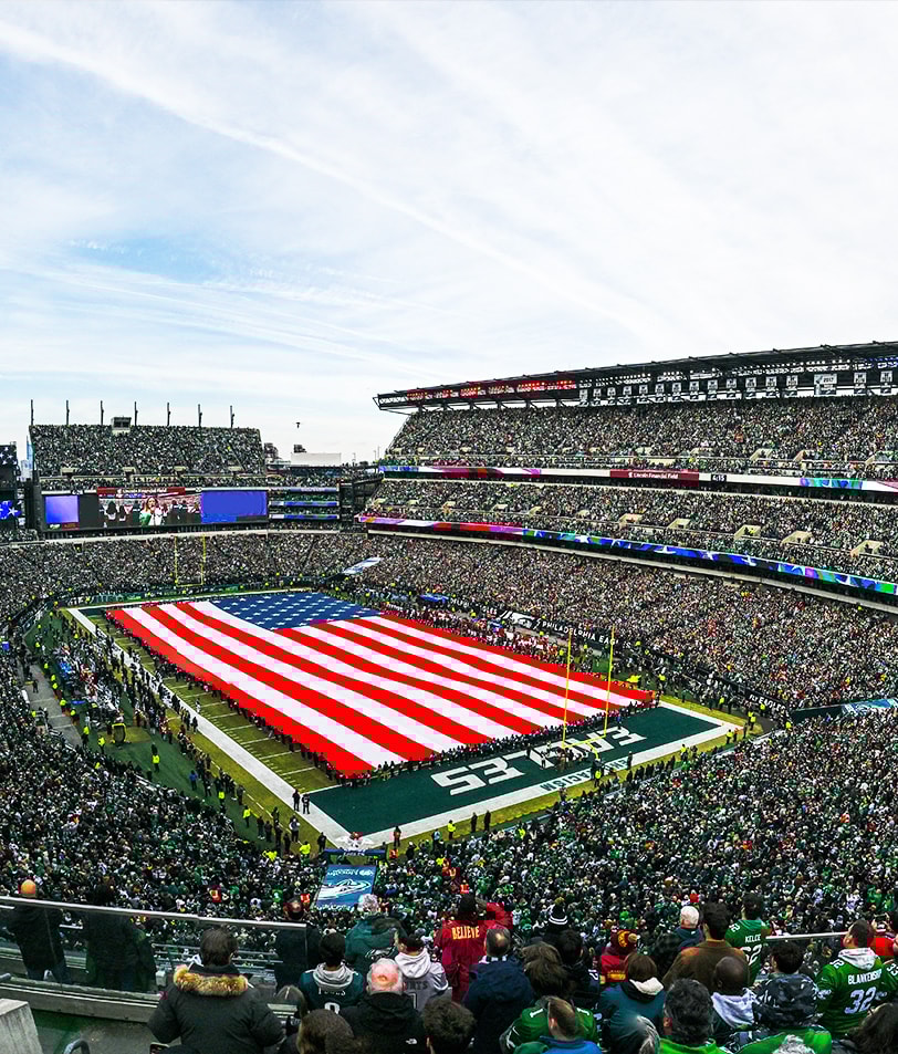{generated} A packed NFL stadium displays a giant US flag across the pitch as fans gather for a high‑energy match day moment.