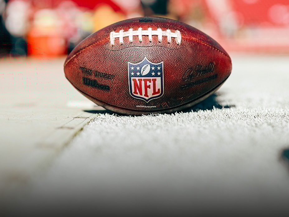 Close-up of a Breitling watch with the NFL logo on the dial