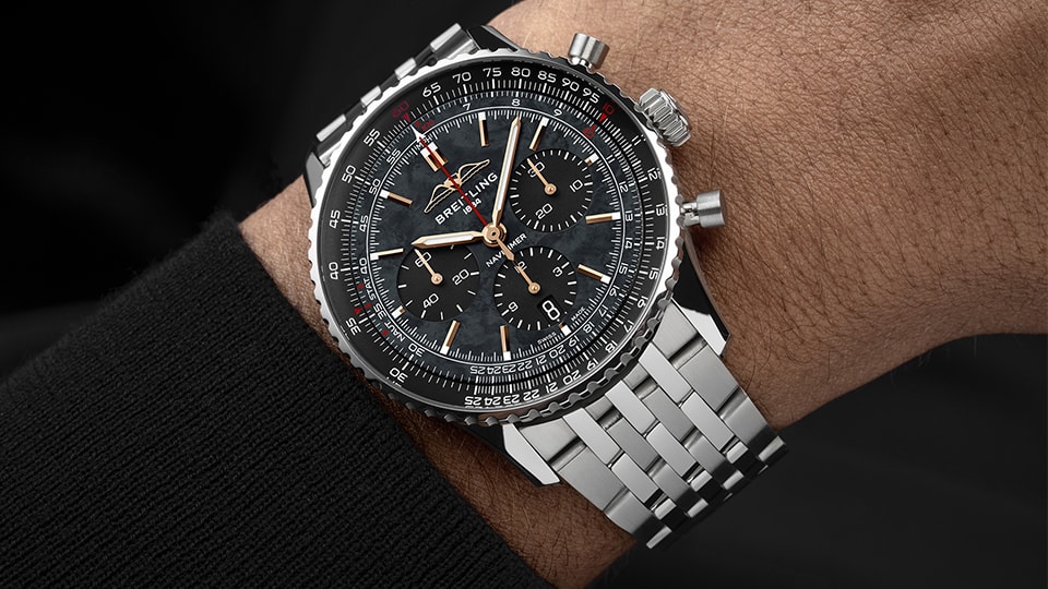 {generated} Breitling Navitimer US Limited Editionが黒い文字盤と磨かれたスチールブレスレットで手首に映える構図。