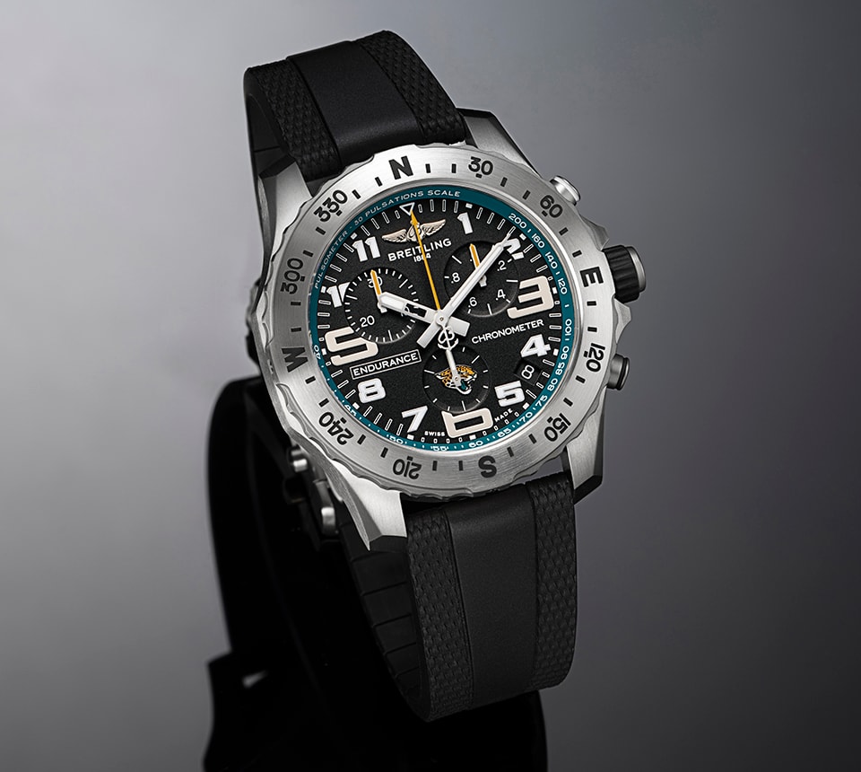 {generated} Breitling Endurance watch with black dial, teal ring, and Jacksonville Jaguars emblem set against a dark backdrop