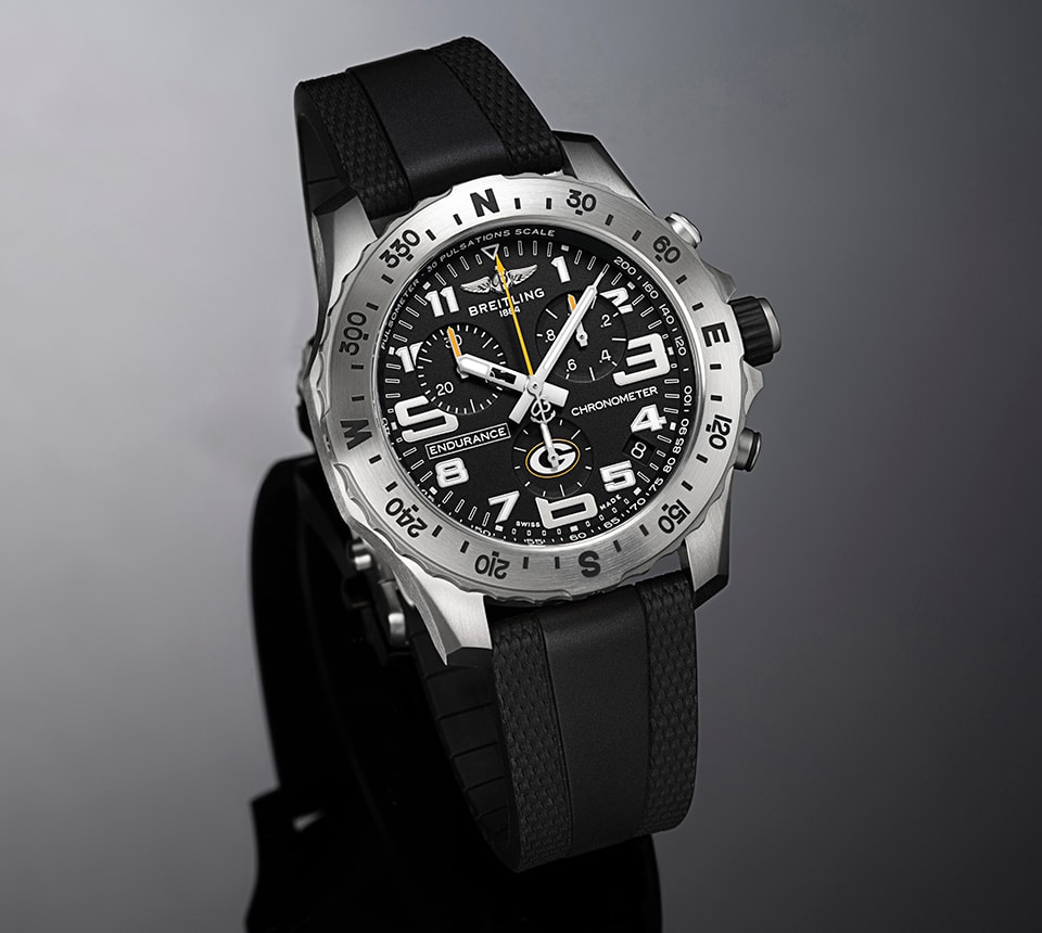 {generated} Breitling Endurance Pro watch with black dial and Packers detail, shown in a sleek close-up highlighting its bold design.