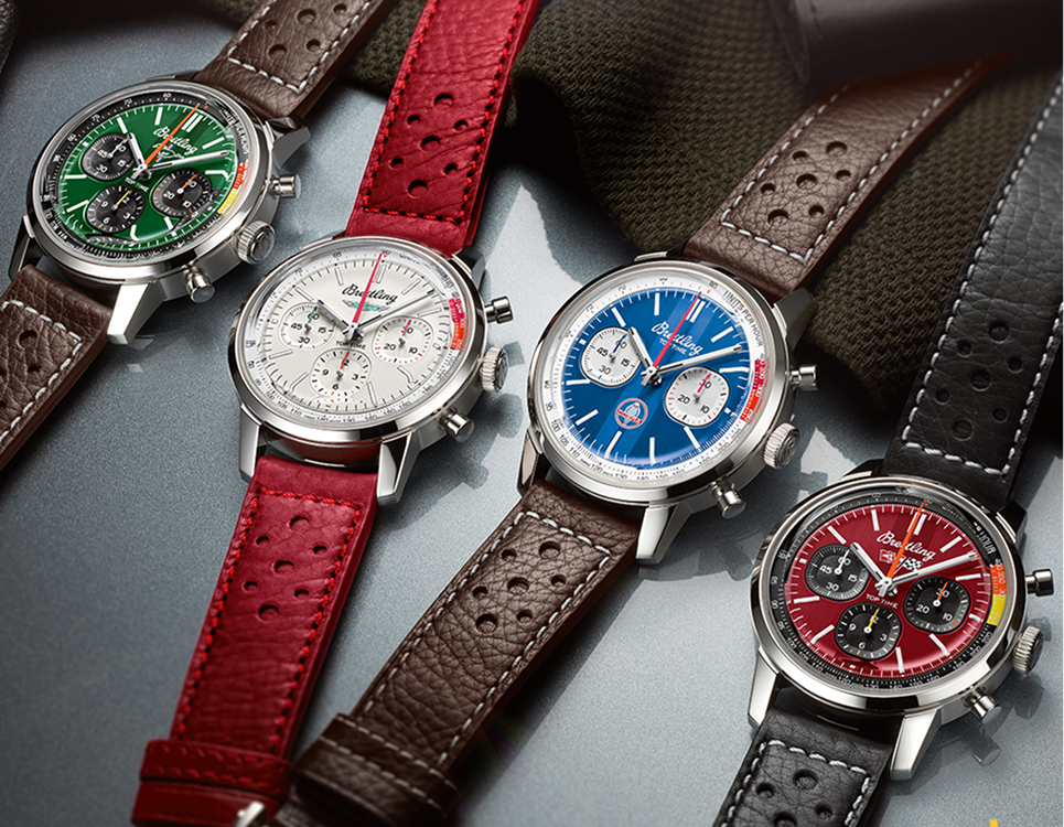 {generated} Quattro cronografi Breitling Top Time con quadranti verdi, argento, blu e rossi e cinturini in pelle traforata