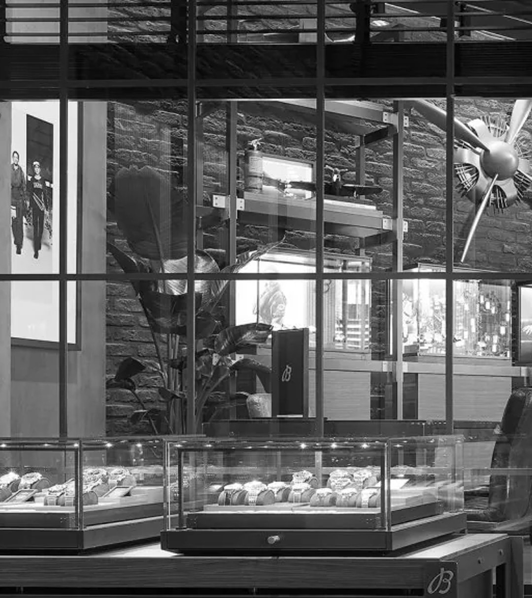 {generated} Elegant Breitling boutique interior with glass displays showcasing watch collections and refined seating near large windows.