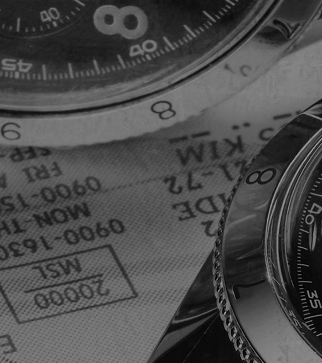 {generated} Close-up of a Breitling Co-Pilot chronograph with black dial and leather strap set against detailed aviation charts.