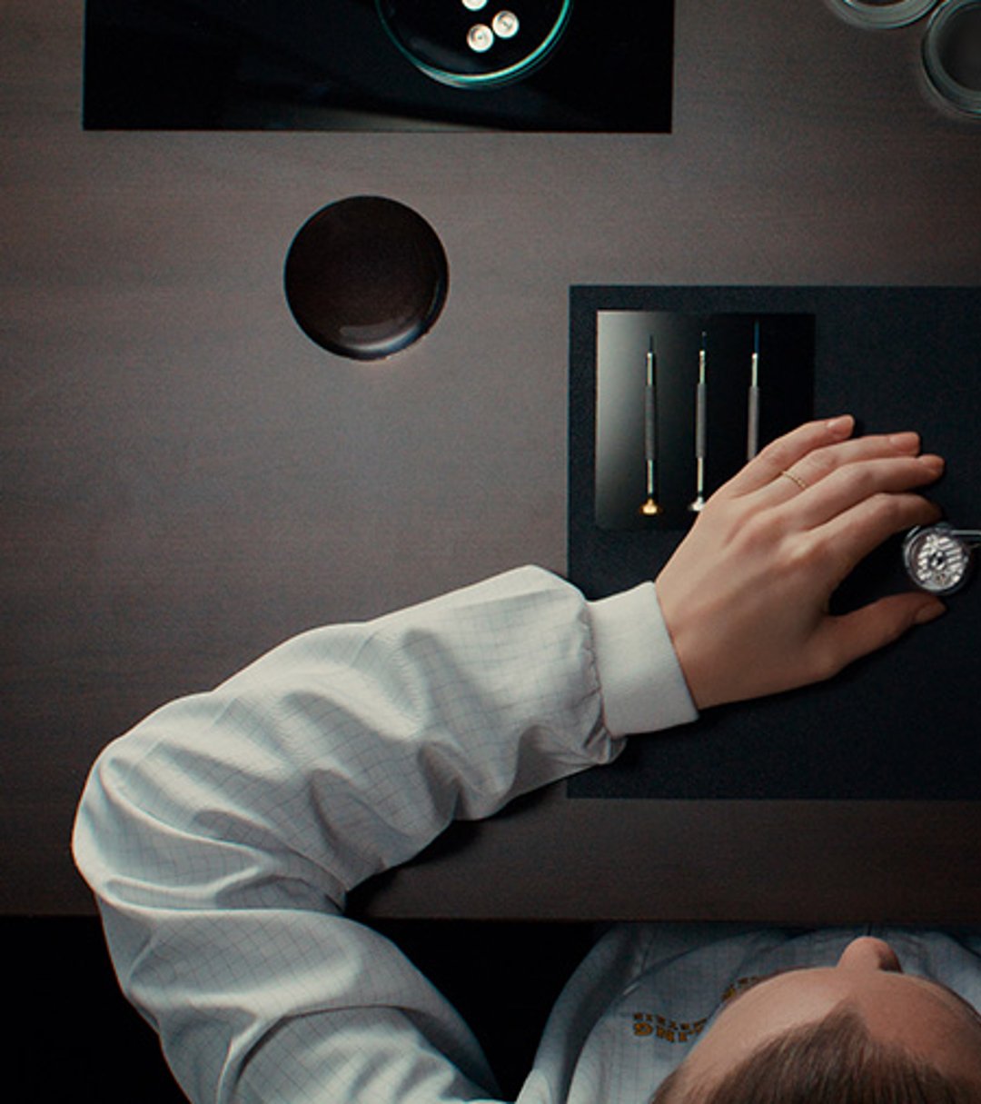 {generated} A Breitling technician carefully assembles a watch movement with precision tools, highlighting expert service craftsmanship.