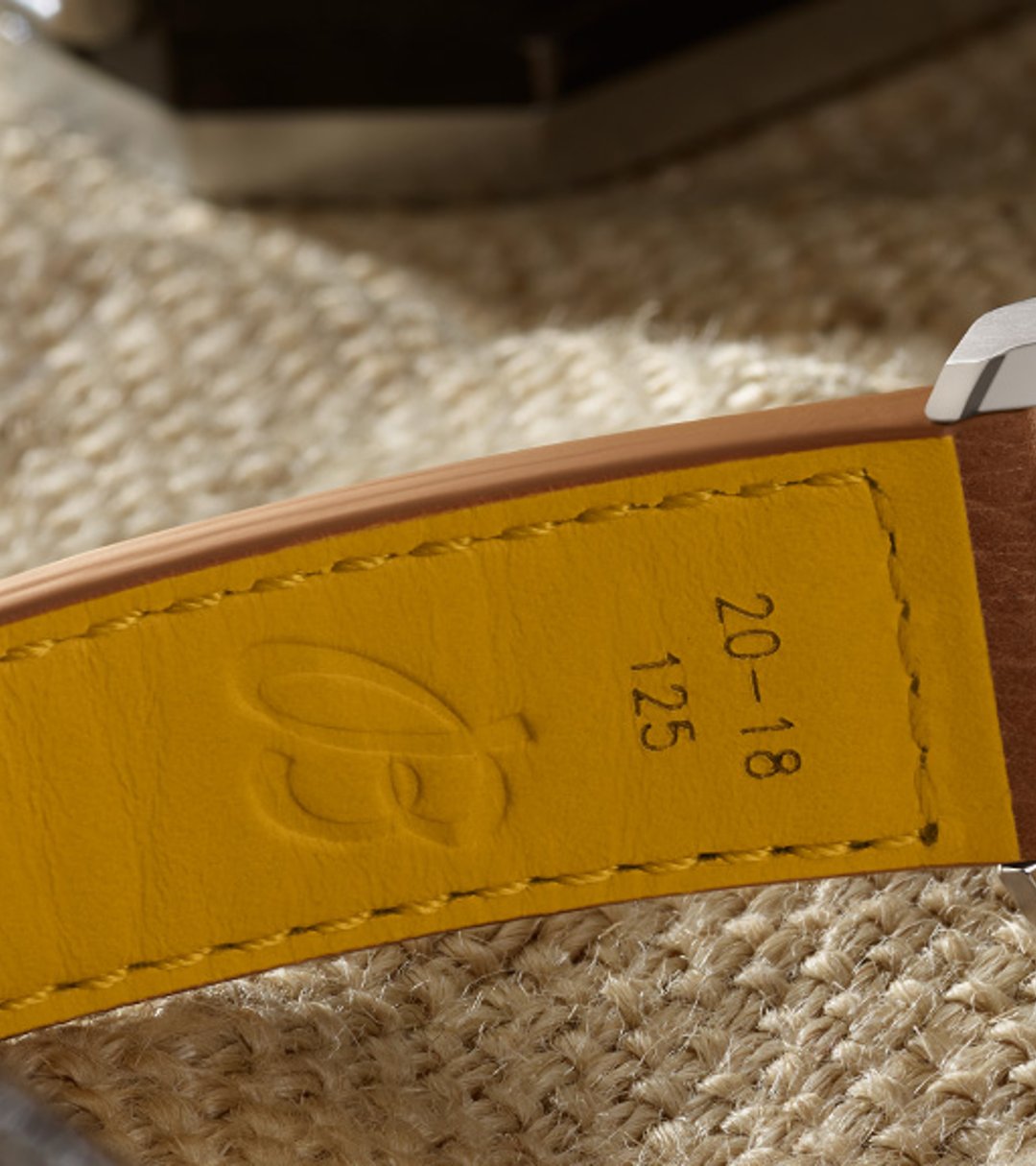 {generated} Breitling Caliber B31 displayed from the caseback, revealing its mechanical movement with leather strap details.